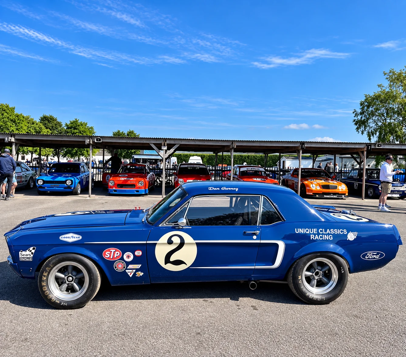 Blue number 2 Mustang race car in the paddock