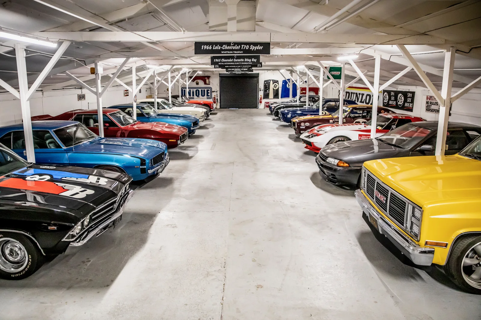 Rows of classic and performance cars inside The Paddock storage facility